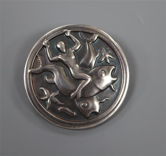 A post 1945 Georg Jensen 925 circular brooch, depiction merman with fish and starfish, design no. 285, 41mm, 10 grams.